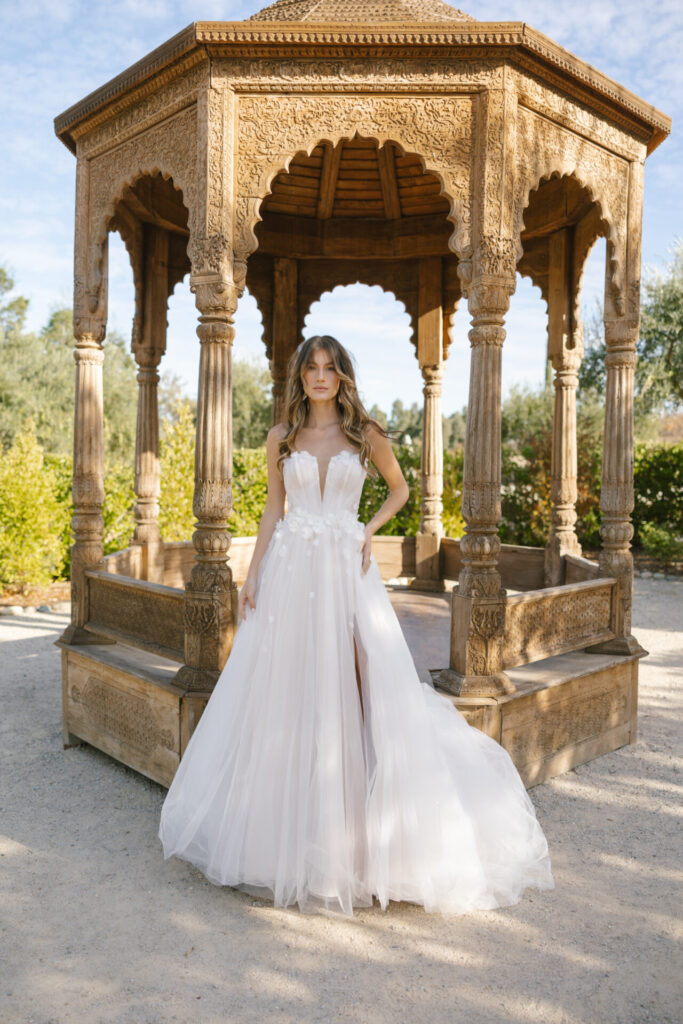 D4065-Essense of Australia-Pure Bridal, ENCHANTING PRINCESS A-LINE WEDDING DRESS WITH SWEETHEART NECKLINE Float down the aisle while lost in reverie wearing Style D4065, an ethereal floral wedding dress with soft textures and delicate embellishments. Detachable off-the-shoulder straps flutter across the upper arm with delicate 3D floral accents before billowing into a modern on-trend puff style. A plunging sweetheart neckline tops the gathered sheer corset bodice and meets a 3D floral-embellished waistline. The softly draped A-line skirt reveals a subtle leg slit with each graceful step, blending vintage charm and contemporary edge. This floral lace wedding dress captures the modern fairy tale essence and is ready for that happily ever after, Edmonton wedding shop, Edmonton wedding dress