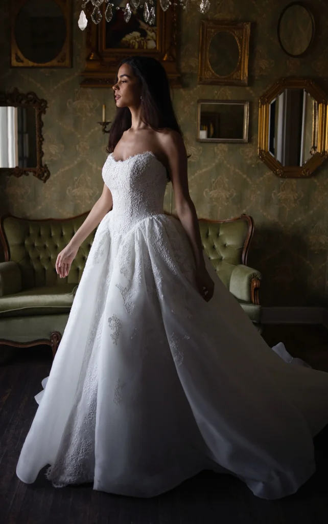 Essense of Australia Style D4573 organza ballgown wedding dress featuring a strapless sweetheart corset bodice, basque waist, and floral lace appliqu&eacute;s at Pure Bridal in Edmonton