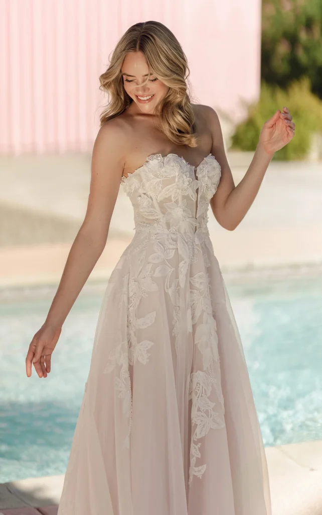 Style SY8166 by Stella York, a romantic floral lace and glitter tulle A-line wedding dress with a strapless structured sweetheart neckline and 3D lace appliqu&eacute;s, available in plus sizes at Pure Bridal boutique in Edmonton.