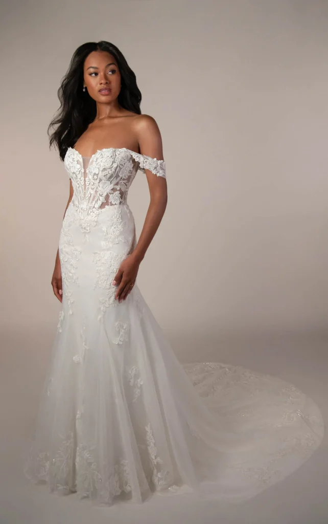 Fit-and-flare wedding dress Style SY8385 from Stella York featuring a plunging neckline and floral lace appliqu&eacute;s, available at Pure Bridal wedding boutique in Edmonton.